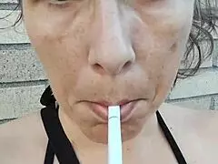 kelly kendricks lights up a cigarette outdoors, flaunting her big cleavage in the sun