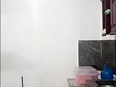 Cute Latina woman casually cooks naked, using dildo on her curvy ass