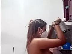 Cute Latina woman casually cooks naked, using dildo on her curvy ass