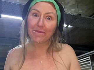 Street girl dancing naked with seductive moves outdoors.