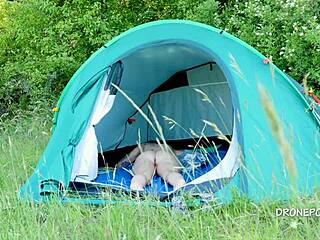 Nudist milf relaxing by the beach tent
