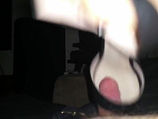Man worships woman's feet in fetish shoefuck session, leading to intense cumshot on soles