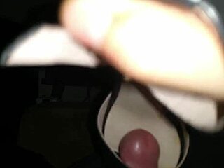 Man worships woman's feet in fetish shoefuck session, leading to intense cumshot on soles