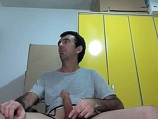 Man does striptease, removing sexy black panties and white blouse, showing big erect cock squirting.