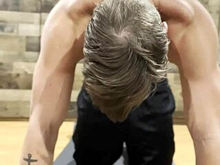 muscular bodybuilder performs intense stretching routine