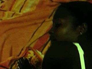 African woman poses in a bent over position for the camera.