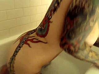 Tattooed beauty in the bath, what secrets does she hide?