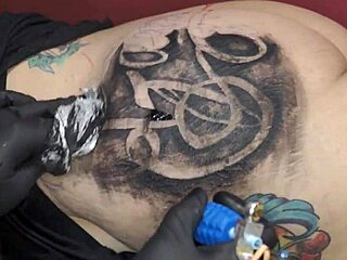 Getting new tattoo on fat ass