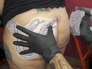 Getting new tattoo on fat ass