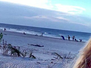 Hot milf teases her pussy on a crowded public beach, drawing voyeur eyes