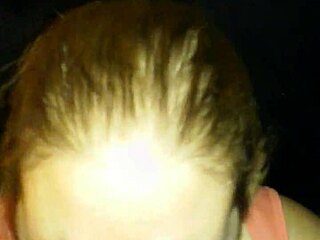 Suggestive interracial scene with husband watching black cock swallow.