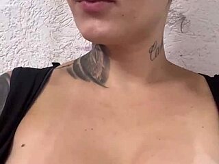 blonde with big tits trains at the gym, sweats heavily, sits to expose her breasts and breathe.