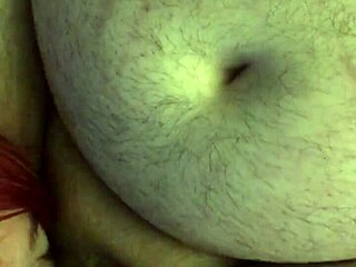 Redhead amateur sucks and licks balls while giving handjob