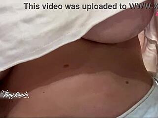 The hot wife heads out shopping without a bra, acting naughty for the seller while flashing her big natural tits outdoors.