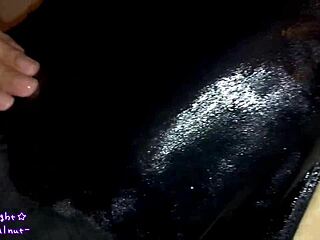 Transsexual in navy blue swimsuit gets coated with slippery lotion