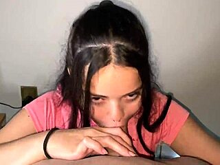 Naughty brunette shows off her hard tits while sucking a big pink cock deeply.