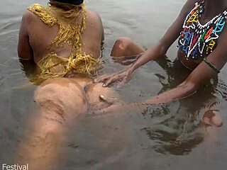 Two women from the tribe bathe together in the village river.