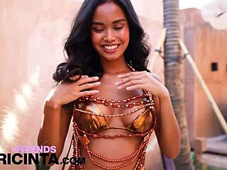 This horny asian babe putri cinta casually strips down to reveal her huge brown tits in a teasing display