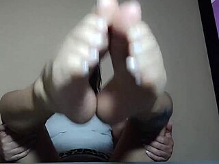 I'm fingering her pussy while she indulges in foot fetish play. She loves every moment of it, getting wetter with each touch.