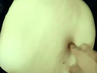 The guy indulges in exploring the curvy milf's navel during an intimate belly massage.