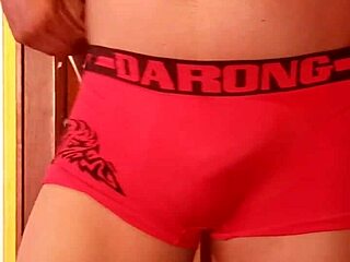 She's casually modeling her wife's panties, slipping in a dildo while lounging in lingerie and nylons.