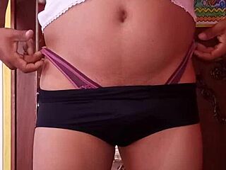 She's casually modeling her wife's panties, slipping in a dildo while lounging in lingerie and nylons.