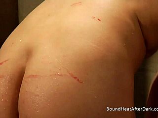 Naked blonde slave bathes while dom mistress fingers and licks her to submission