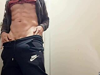 Muscular hunk strokes monster cock in public bathroom thrill