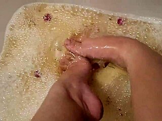 Sexy tattooed babe washes bare feet with rose petals softly
