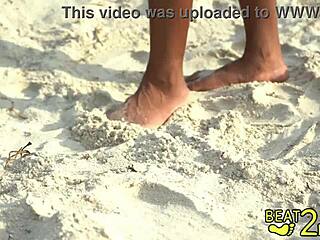 giggles' bare feet tickled sandy on beach close-up
