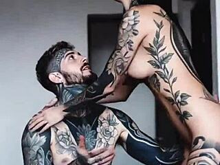 Tattooed skin glistens in intimate couple moments with artistic ink designs.