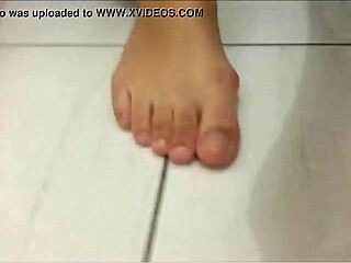 Black socks peel off slowly as she spits on teasing Brazilian feet