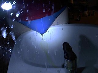 woman pees blue underpants directly over sink