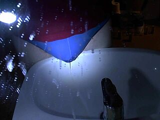 woman pees blue underpants directly over sink