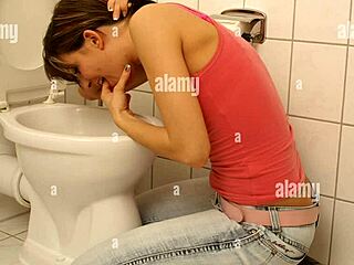 Girl fingers pussy while puking in bathroom
