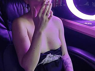 Elegant lady's seductive ritual with a glowing cigarette draws you closer