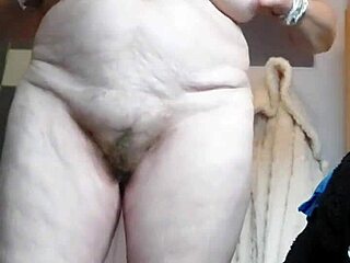 German granny inserts cucumber into hairy pussy