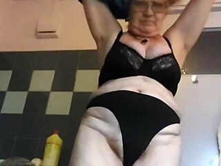 German granny inserts cucumber into hairy pussy