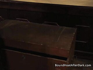 Her mistress fastens a tight collar and chain around the bound lesbian slave's neck for total bdsm submission