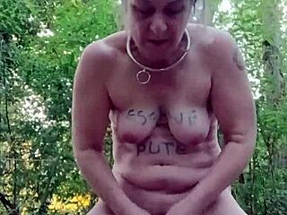 female slave bound outdoors flashes tits and takes doggystyle in forest