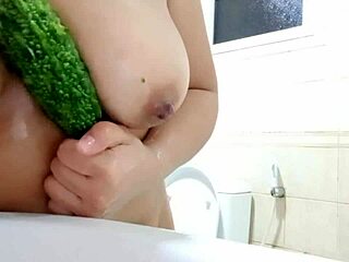 damn, check this chubby babe sliding cucumber between her oiled big tits