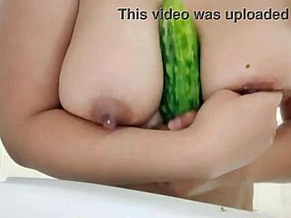 damn, check this chubby babe sliding cucumber between her oiled big tits