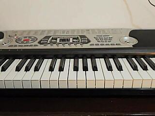 Beautiful Young Woman Plays Piano In Pink Skirt