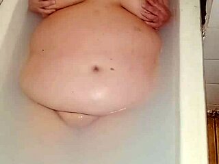 Curvy big tits wife plays naked wet pussy closeup in steamy bathtub
