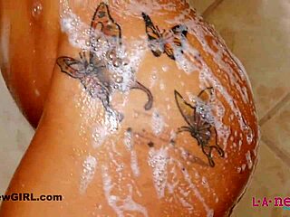 a black tattooed cutie with big sexy tits and hairy pussy teases nipples in steamy hd shower