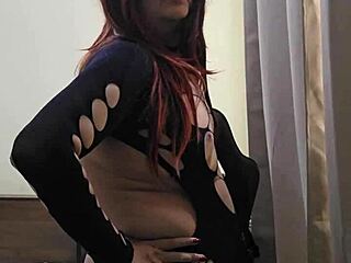 Redhead shemale Monica M teases small tits and ass in fishnets