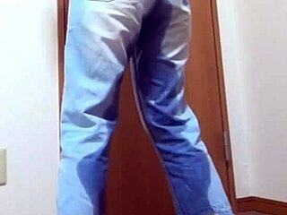 Desperate girl soaks jeans peeing while bro hogs the bathroom