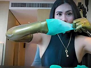Mistress slips on latex gloves for steamy rubber fetish tease and domination play