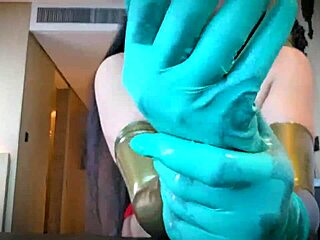 Mistress slips on latex gloves for steamy rubber fetish tease and domination play
