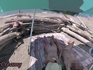 Wife gives outdoor handjob with cumshot on beach
